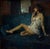 On the Phone by Ron Hicks | Oil Painting of a woman sitting on a couch with a telephone For Sale