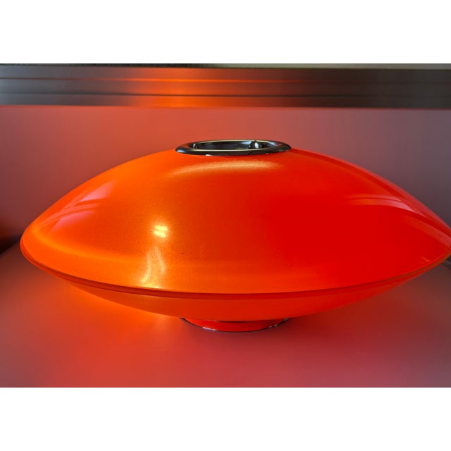 Orange lamp made of two glasses, with chrome finishes that take you back to the glorious 70s. European Plug (up to...