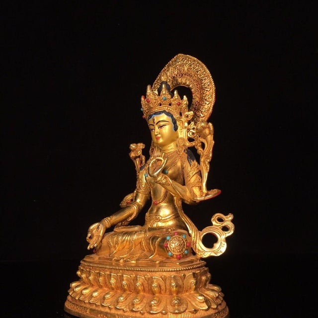 This is a finely crafted gilt bronze sculpture of White Tara, a revered female Bodhisattva in Tibetan Buddhism associated...