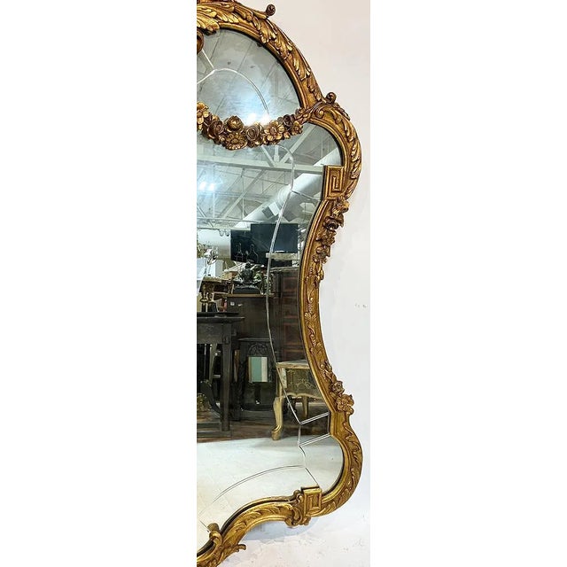 This Large 54 Inch Antique French Gilt Mirror is a stunning piece that exudes elegance and style. The gold color and...