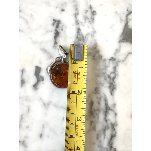 Lovely vintage sterling silver and amber pendant charm with sterling silver leaf design. Represents a hanging fruit.
