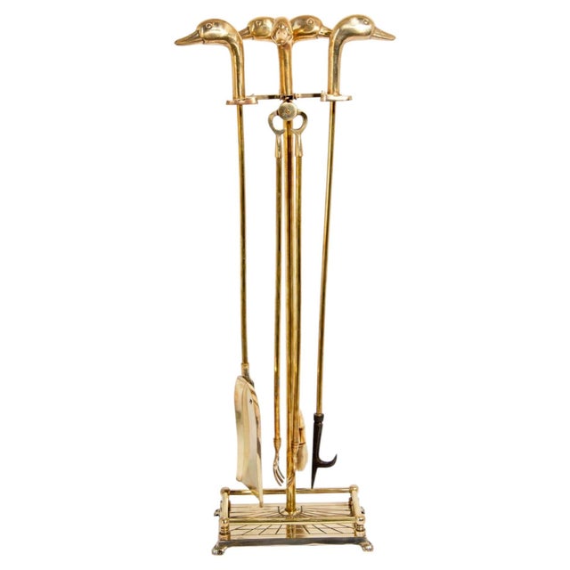 An exceptionally decorative vintage French five-piece fireplace tool set, circa 1950s, crafted in solid polished brass and...