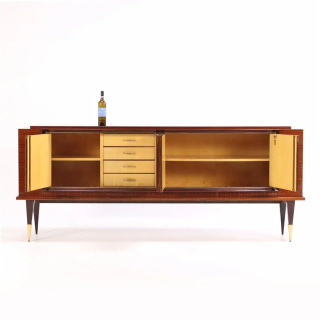 This striking sideboard showcases the streamlined elegance of French Art Deco design. Its exterior features rich, exotic...