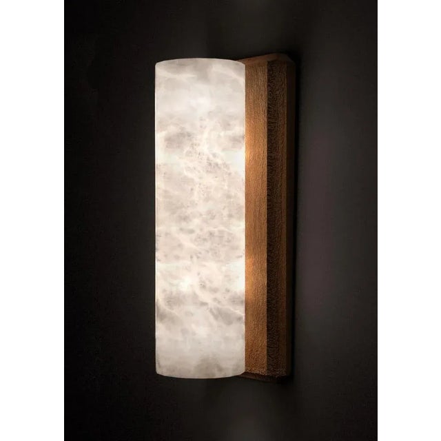 Kendō 2 small iroko wood applique by alabastro italiano dimensions: ø 14 x h 34 cm. Materials: white alabaster and iroko...
