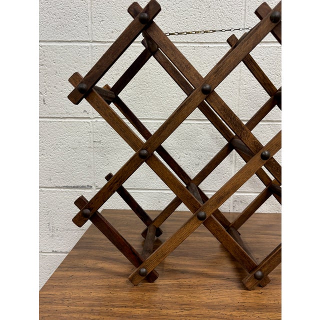 This is a vintage 8 slot accordion collapsible wooden wine rack. Dimensions: - 21.5 in wide - 8 in deep - 15 in tall
