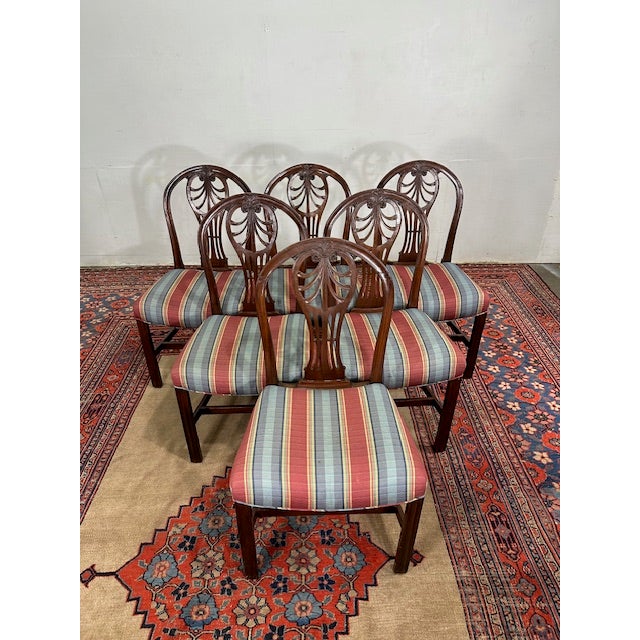 Elevate your dining experience with this exquisite set of six antique dining chairs. Each chair features beautifully...
