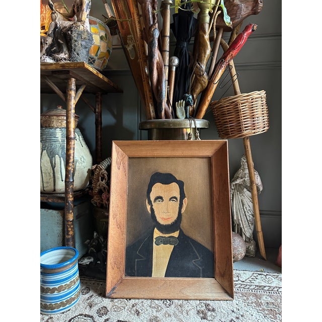 Mid-20th-century American folk revival portrait of Abraham Lincoln, hand-painted in oil on canvas board in a naïve, self-...