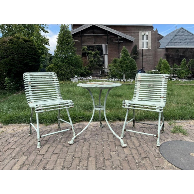 What great charm, this Antique French Arras set consisting of a garden table with 2 chairs. The set has a wrought iron...