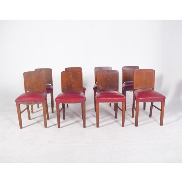 Set of eight Deco-style dining chairs. Sober lines and a sturdy wooden frame, they have a functional, modern-inspired...