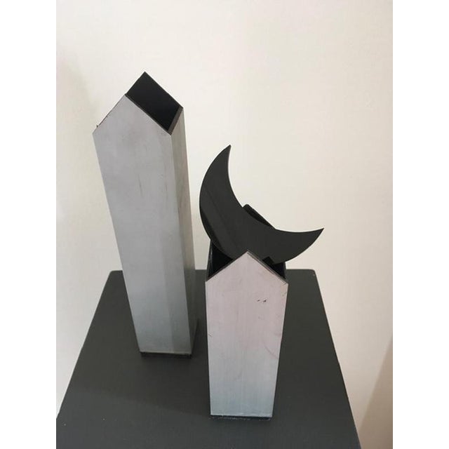 The twins in aluminium are a pair of metaphysical houses, the moon in black acrylic glass is free and can be put on the...