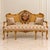 This exquisite French Rococo-inspired sofa combines plush beige velvet upholstery with an elaborately carved wood frame...