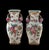 Beautiful matched pair of vases featuring vibrant fruit and floral motifs with dimensional sculptural pomegranate handles....