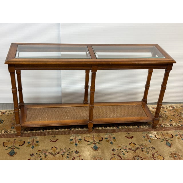 Design Plus Gallery presents a Vintage Faux Bamboo Console Table. The console has an elevated coastal resort style with...