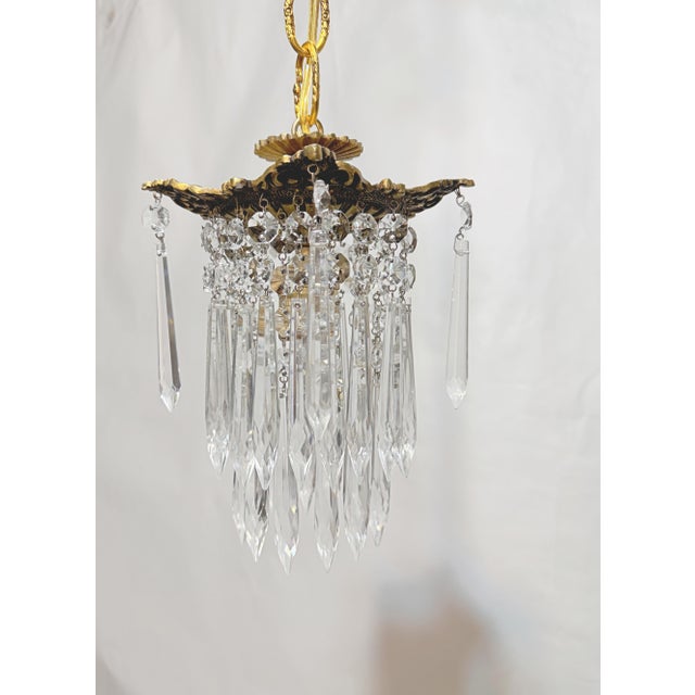 This is a decorative brass frame rim chandelier with layered octagon bead chains and 30% leaded U-drop crystals. It has 1...