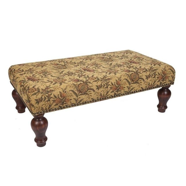 Meticulously handcrafted in the United Kingdom, this upholstered stool boasts classic studding and hand-polished solid...