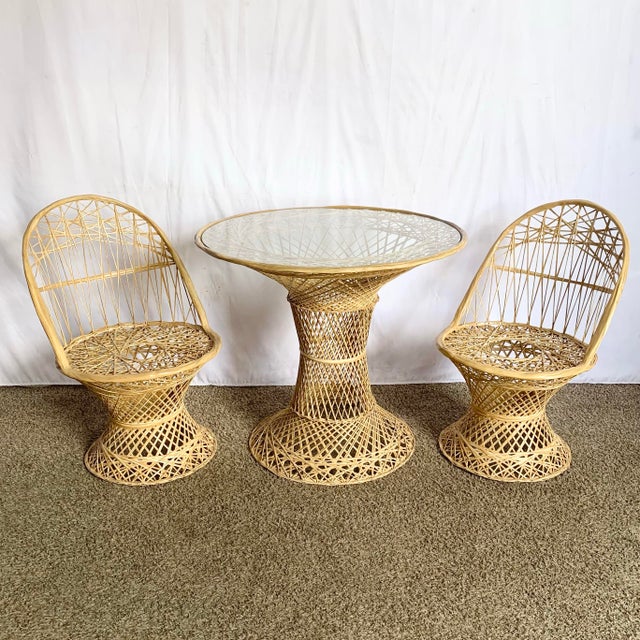 This mid-century modern spun fiberglass dining set includes a round glass-top pedestal table and two matching chairs, each...