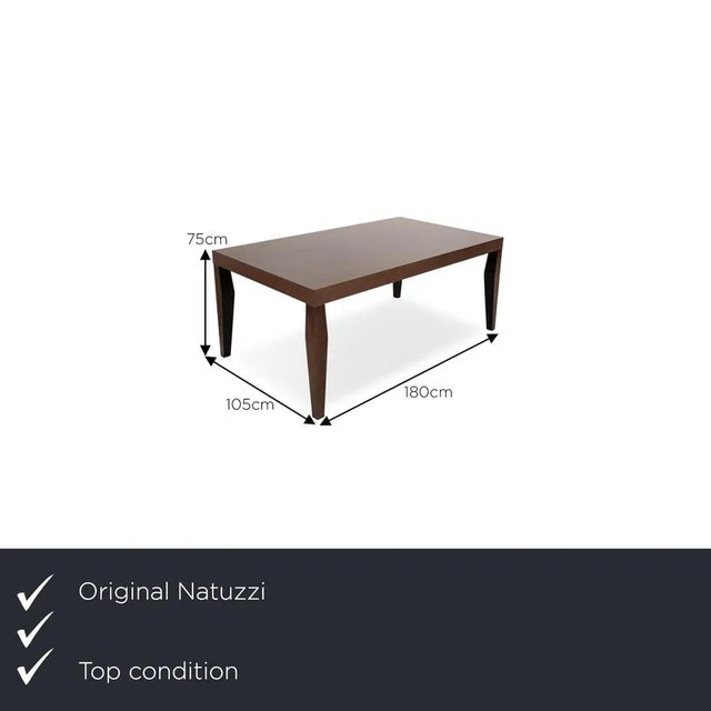 The dining table from Natuzzi consists of a brown frame and a wooden table top. It impresses with its rustic design and...