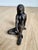 A masterful example of Brutalist figurative art, this solid cast bronze sculpture depicts a seated female figure in a...