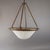 Elegant pendant features a large satin glass bowl fitted into brass ring, held by brass rods that lead up to an...