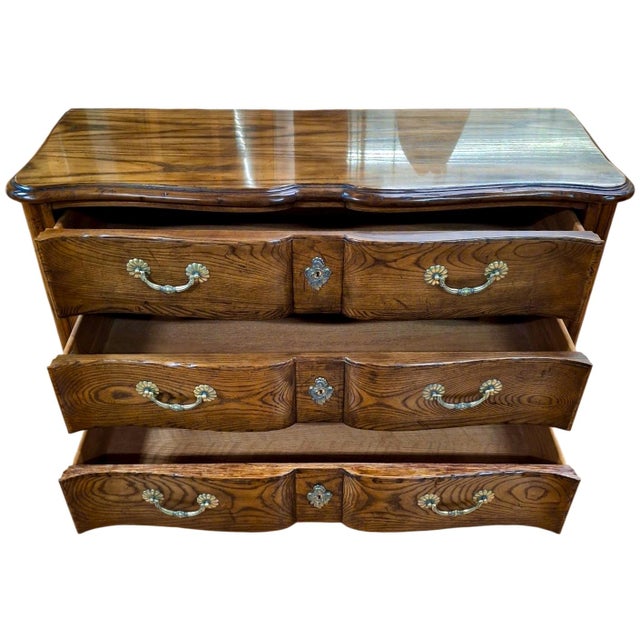 On offer is an exceptional vintage piece of American craftsmanship by Baker Furniture Company. This chest of drawers was...