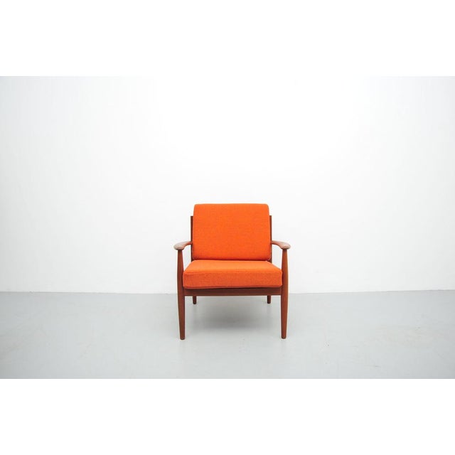 Lounge chair by Grete Jalk in teak with loose cushions. The cushions have been reupholstered in Kvadrat's "Hallingdahl 65"...