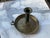 Early New England Brass candle stand on brass saucer with finger hold. Key shaped push up.