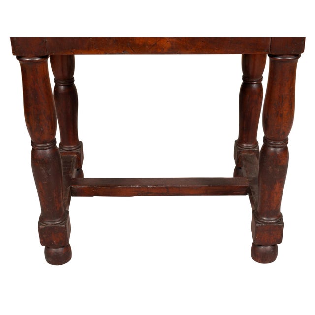 Rectangular upholstered seat raised on turned legs joined by H form stretchers.