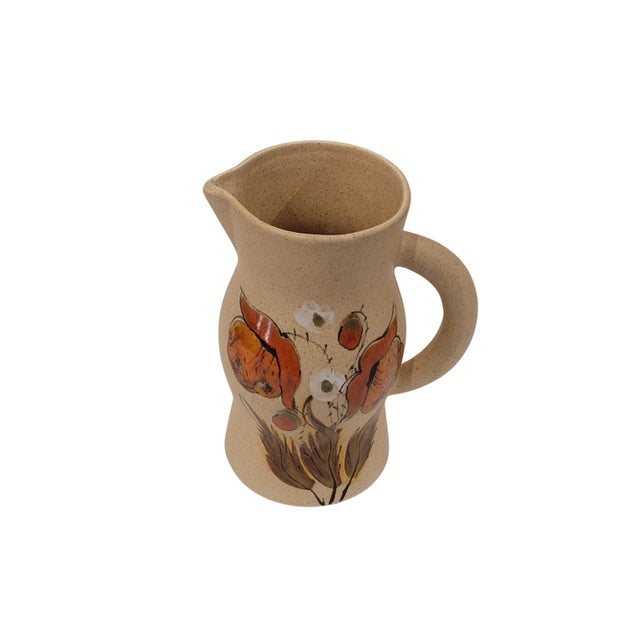 A delicate set comprising a pitcher and six ceramic cups, made in France in the mid-20th century. All pieces feature hand-...