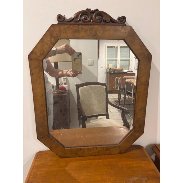 A striking mirror with an octagonal shape framed by a wide veneer of burr wood, its amber and gold highlights...