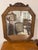 A striking mirror with an octagonal shape framed by a wide veneer of burr wood, its amber and gold highlights...