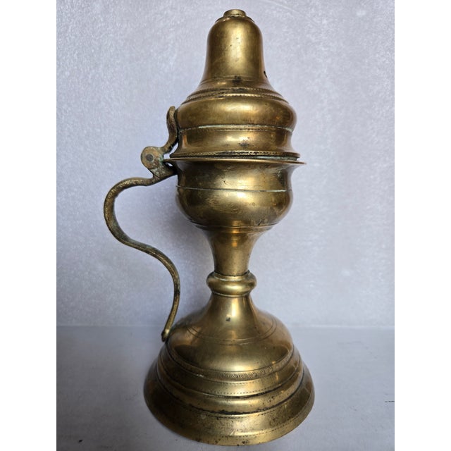 This is a religious artifact is used in the liturgical practices for burning charcoal incense. It features a pedestal base...