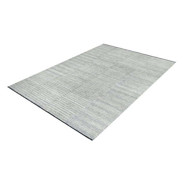 An elegant, hand-knotted contemporary Afghan kilim featuring a sophisticated, minimalist design and delicate shades of...