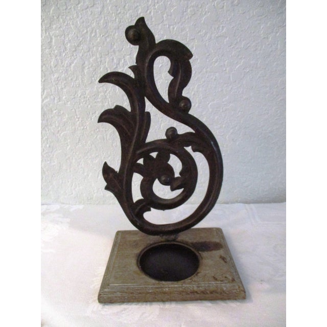 Stylish pair of distressed wood and metal candle holders. Ornate metal design mounted on distressed wood bases. Each holds...