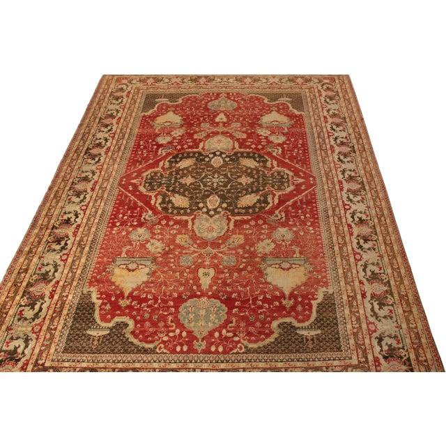 An antique 10x14 rug of the celebrated Turkish Hereke style, hand knotted in wool circa 1920–1930. This particular...