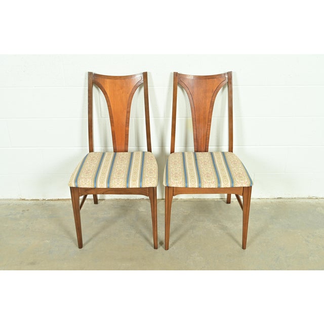 A gorgeous pair of Mid-Century Modern side chairs or dining chairs By Broyhill Brasilia USA, 1960s Sculpted walnut frames,...
