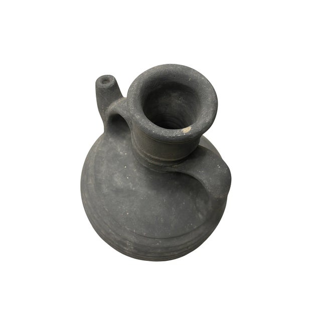 This handcrafted amphora-style vessel captures the timeless elegance of Mediterranean design. Made in Egypt, it reflects...