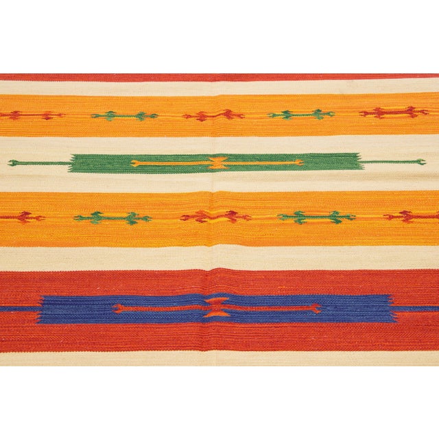 Beautiful Modern Kilim hand-knotted wool rug with multicolor accents in an all-over geometric design. This rug measures...