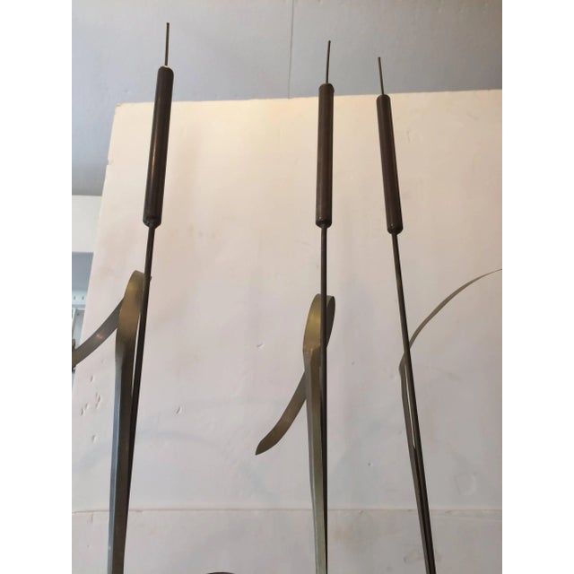 Very striking modern sculpture having three elongated brass stalks of wheat that stand upright in a sleek custom white...