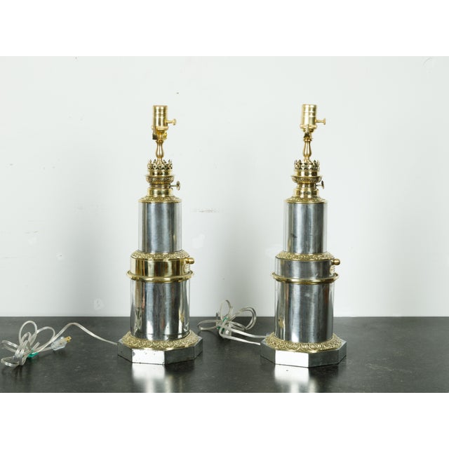 A pair of French Gagneau Paris steel and brass table lamps from the early 20th century with waterleaf motifs. Created in...