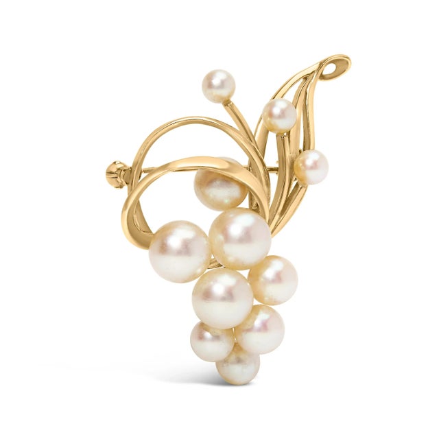 Drape yourself in the opulence of the Orient with this exquisite brooch, where eleven Japanese Akoya pearls, ranging from...