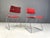 Set of 8 stackable dining chairs designed by Rudi Verelst. The have a heavy wired chrome frame with newly upholstered red...