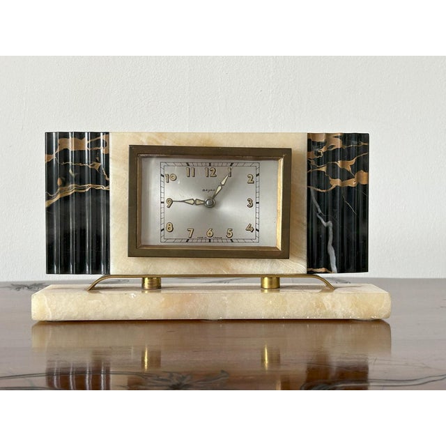 Bayard - Art Deco Marble Table Clock, France, 1930s A table clock with a white enamel and brass dial and an alabaster and...