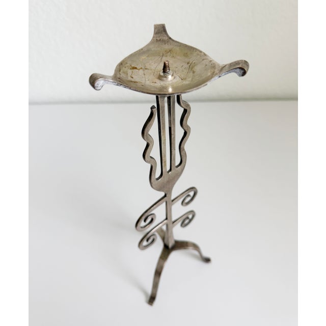 Whimsical candlestick, circa 1980s. Features scrolling and wavy stylized forms, evoking organic, biomorphic shapes. Aged...