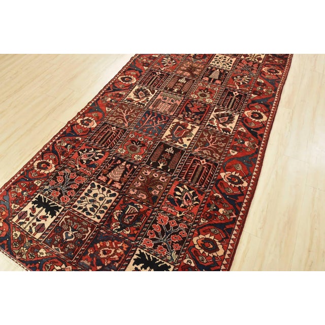 This authentic semi-antique traditional tribal Bakhtiari rug is hand-knotted with fine wool and natural dyes. This...