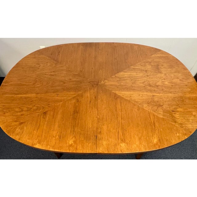 Great mid century style extension dining room table. Clean, simple, Scandinavian inspired lines. Oval top with diagonally...