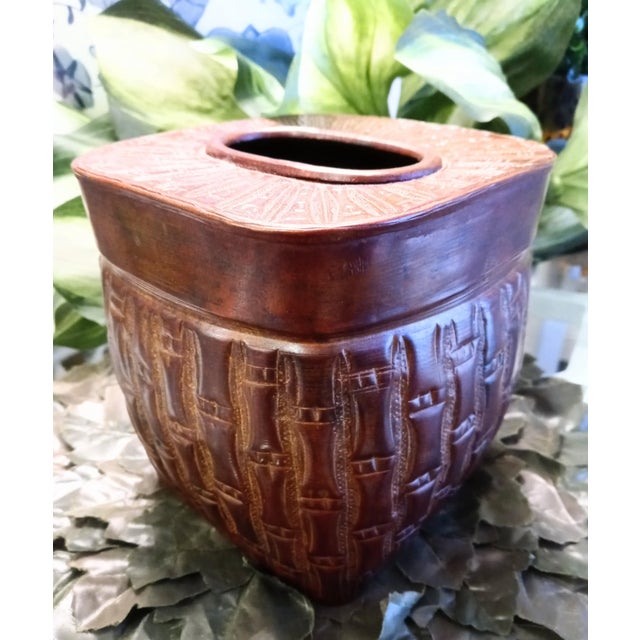 A metal faux bamboo dark stain tissue box holder. The box has pretty details with a dark faux finish stain.