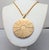 1970s goldtone round engraved horoscope pendant necklace with spring ring clasp. Marked "NAPIER©" on the back. Pendant...