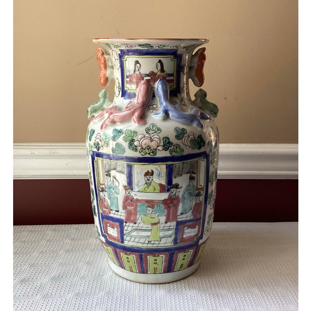 A striking example of Chinese artistry, this large vintage Famille Rose porcelain vase commands attention with its vivid...