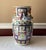 A striking example of Chinese artistry, this large vintage Famille Rose porcelain vase commands attention with its vivid...