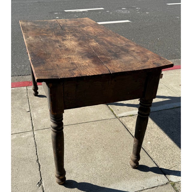 Description This 19th century primitive farm table embodies the quiet strength and authenticity of early rural...